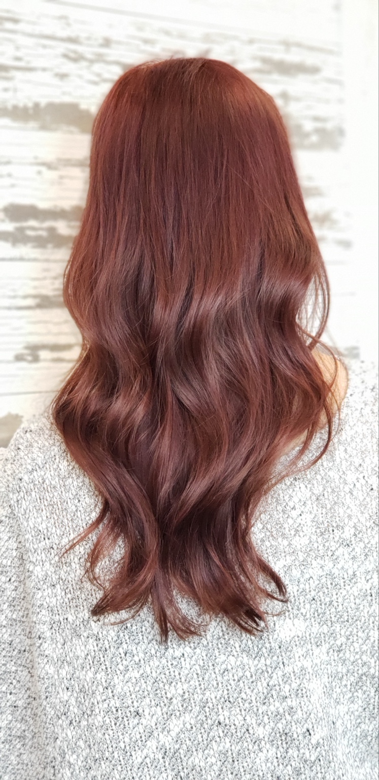 Long copper dimensional hair color with soft waves
